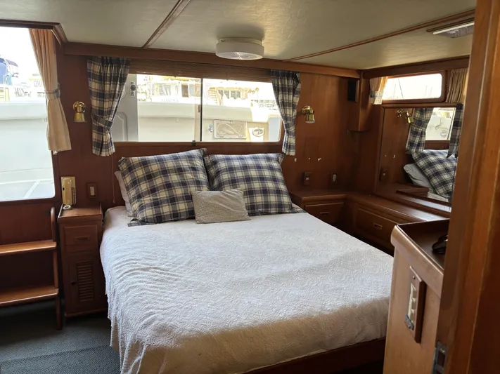 Day Light Yacht Photos Pics Cozy bedroom interior of 1968 Hatteras 58 CPMY yacht with plaid accents and wood paneling.