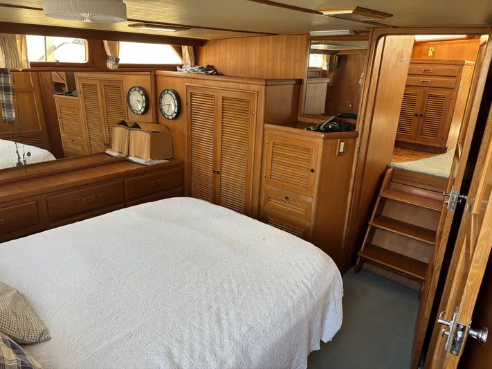 Day Light Yacht Photos Pics 1968 Hatteras 58 CPMY yacht interior with wood paneling and cozy bedroom.