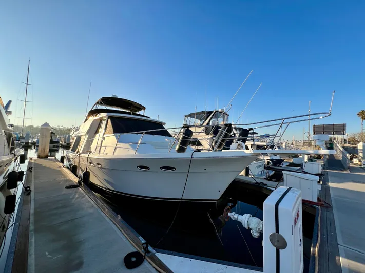 Mamba Mentality Yacht Photos Pics 2008 Meridian 490 Pilothouse yacht docked at marina under clear blue sky.
