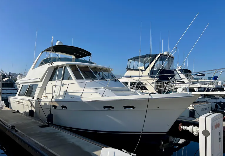 Mamba Mentality Yacht Photos Pics 2008 Meridian 490 Pilothouse yacht docked at marina under clear blue sky.