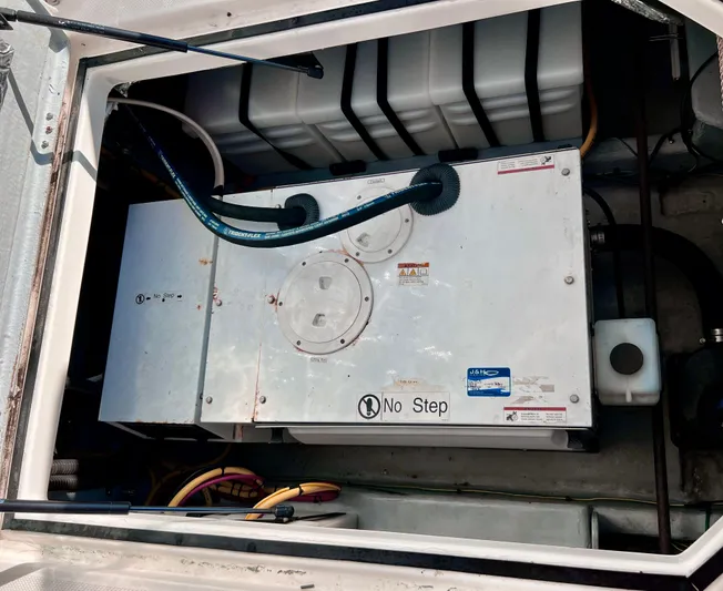 Mamba Mentality Yacht Photos Pics Engine compartment of 2008 Meridian 490 Pilothouse with "No Step" warning label.