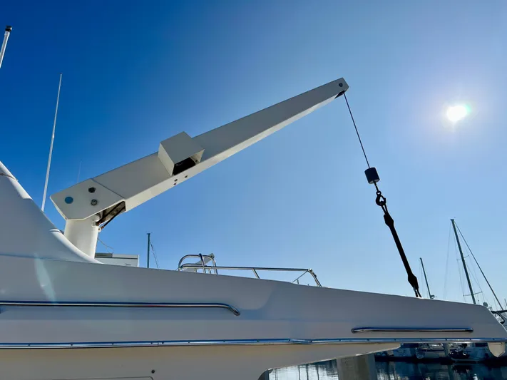 Mamba Mentality Yacht Photos Pics 2008 Meridian 490 Pilothouse yacht with crane under clear blue sky.