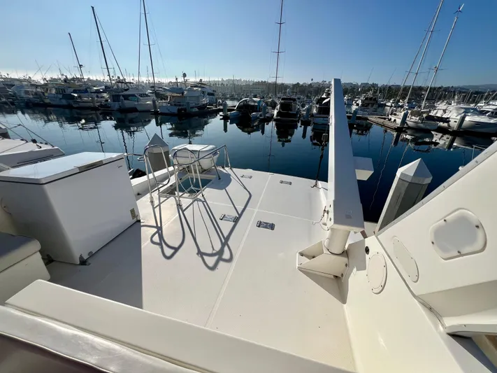 Mamba Mentality Yacht Photos Pics 2008 Meridian 490 Pilothouse yacht deck at marina, surrounded by boats.