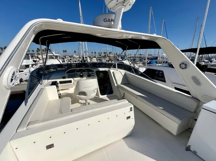 Mamba Mentality Yacht Photos Pics 2008 Meridian 490 Pilothouse yacht interior with seating and helm, docked at marina.