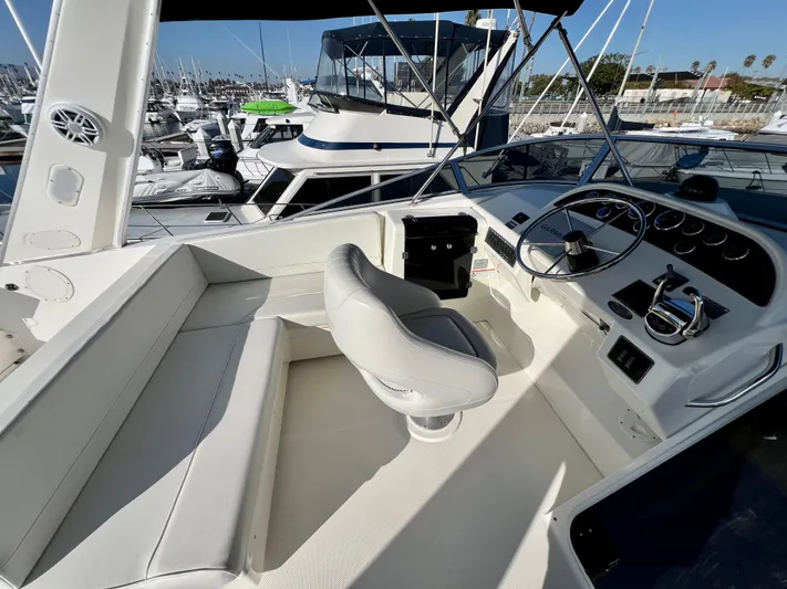 Mamba Mentality Yacht Photos Pics 2008 Meridian 490 Pilothouse helm with seating, docked in a marina.