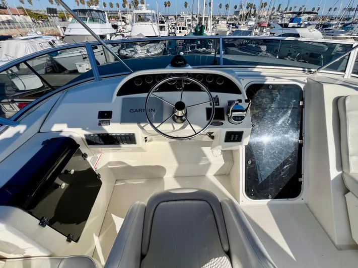 Mamba Mentality Yacht Photos Pics 2008 Meridian 490 Pilothouse helm with Garmin navigation, docked in a marina.