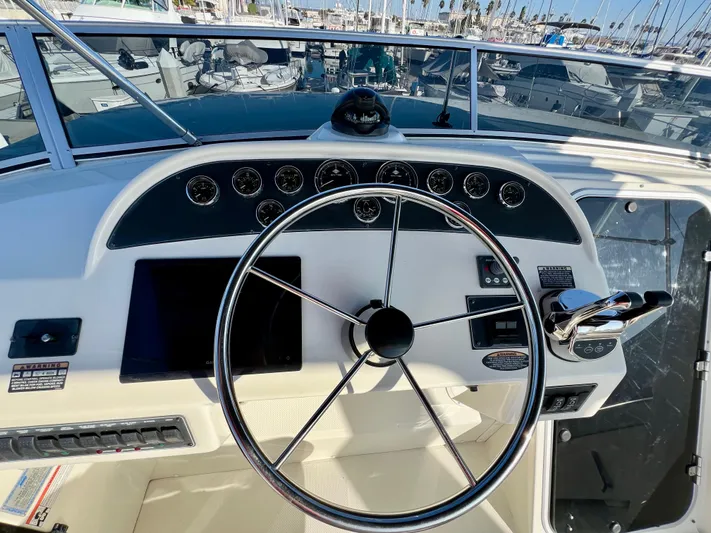 Mamba Mentality Yacht Photos Pics 2008 Meridian 490 Pilothouse helm with steering wheel and control panel.