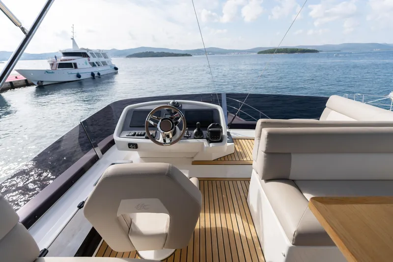  Yacht Photos Pics Flybridge of 2022 Beneteau Monte Carlo 52 yacht with scenic ocean view.