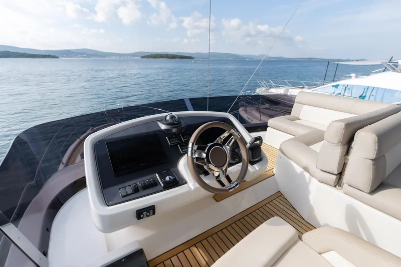  Yacht Photos Pics Luxurious helm of 2022 Beneteau Monte Carlo 52 yacht with scenic ocean view.