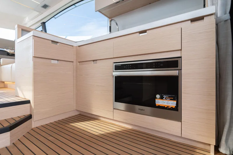  Yacht Photos Pics Modern kitchen in 2022 Beneteau Monte Carlo 52 yacht with built-in Whirlpool oven.