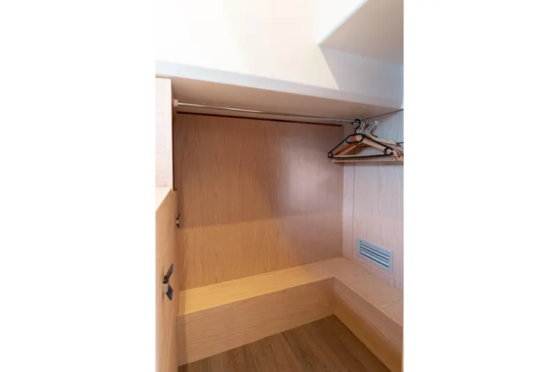  Yacht Photos Pics Wooden closet interior with hangers in 2022 Beneteau Monte Carlo 52 yacht.