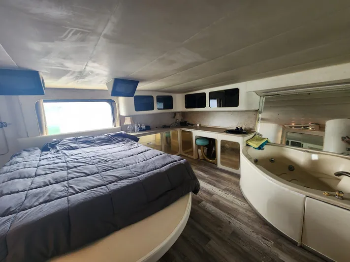  Yacht Photos Pics Luxurious interior of 1984 Infinity Express with bed, jacuzzi, and modern amenities.