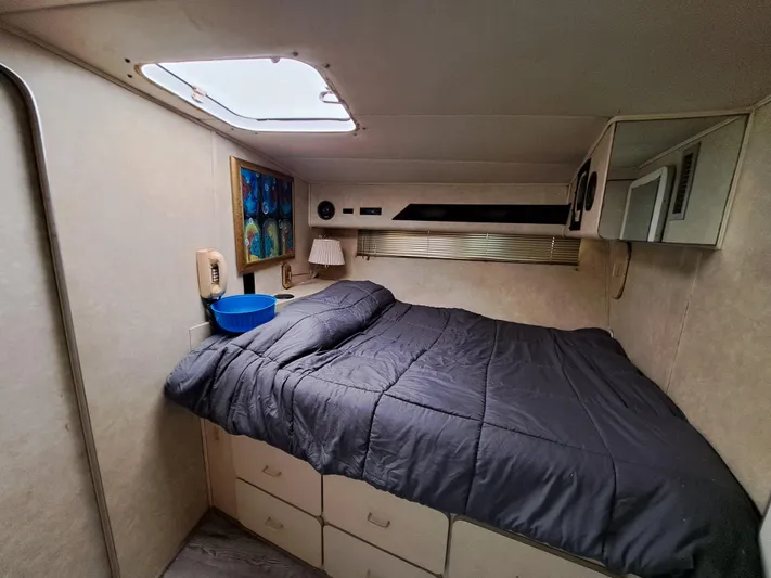 Yacht Photos Pics Cozy bedroom in 1984 Infinity Express RV with skylight and storage drawers.