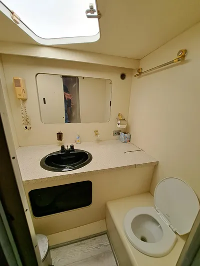  Yacht Photos Pics 1984 Infinity Express bathroom with sink, toilet, and mirror.