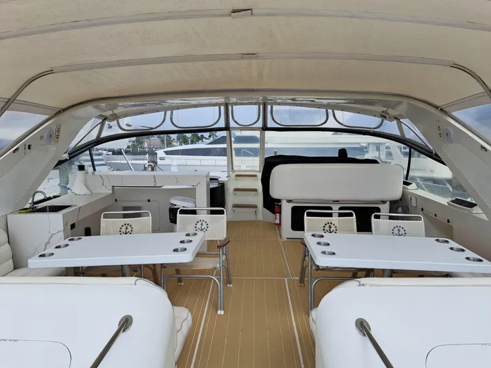  Yacht Photos Pics Luxurious 1984 Infinity Express yacht interior with seating and tables.