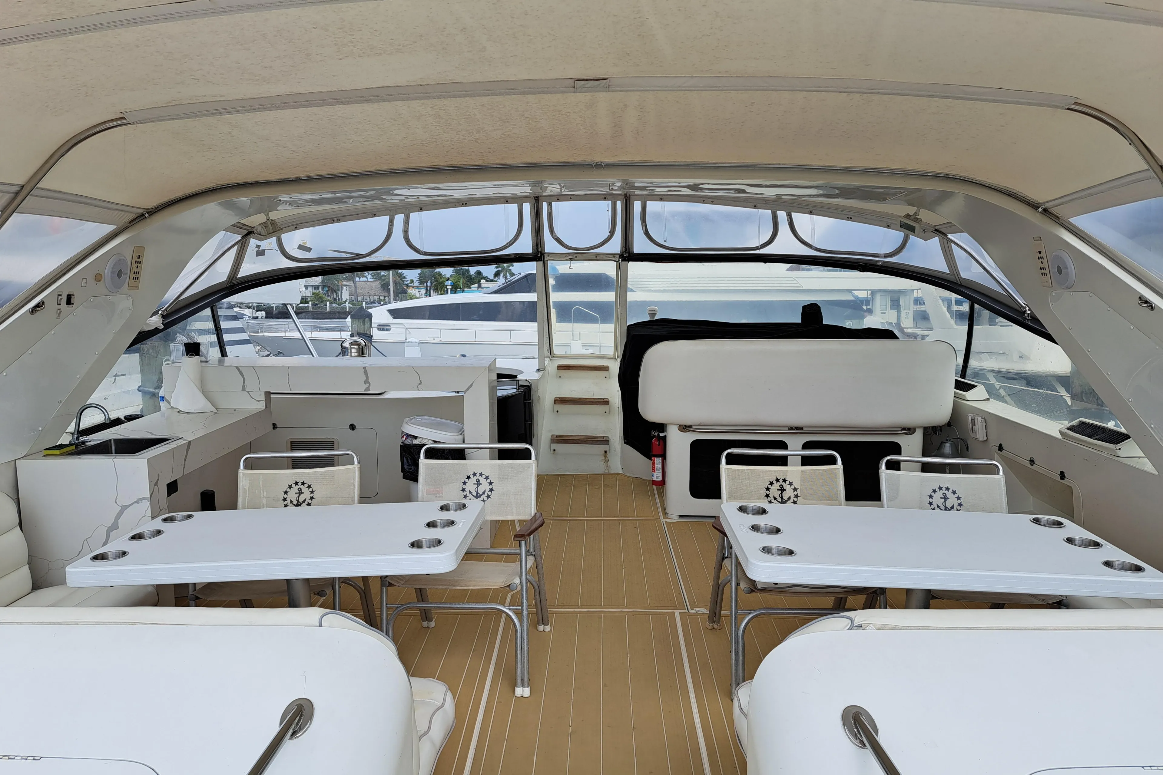 Luxurious 1984 Infinity Express yacht interior with seating and tables.