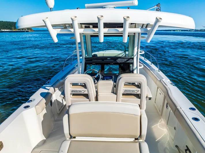  Yacht Photos Pics 2017 Boston Whaler 330 Outrage boat interior with helm, seats, and ocean view.