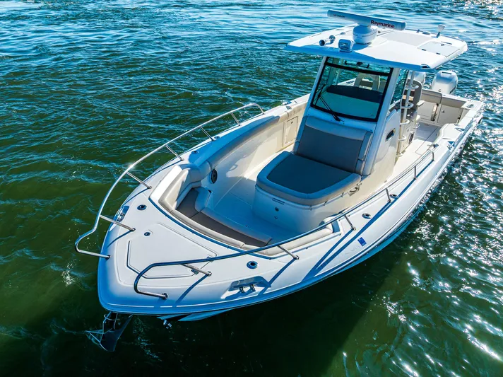  Yacht Photos Pics 2017 Boston Whaler 330 Outrage boat on water, showcasing sleek design and spacious deck.