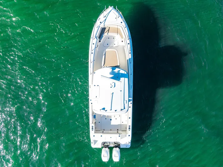  Yacht Photos Pics Aerial view of 2017 Boston Whaler 330 Outrage boat on clear green water.