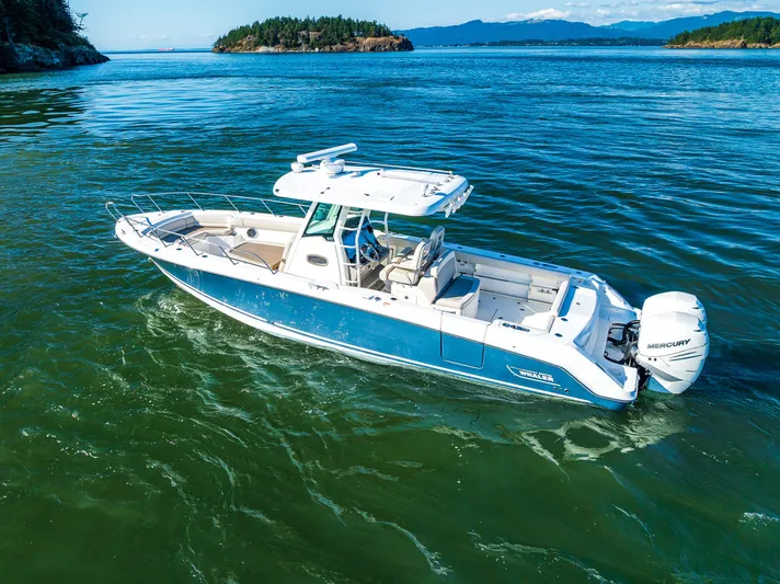  Yacht Photos Pics 2017 Boston Whaler 330 Outrage boat cruising on scenic blue waters.