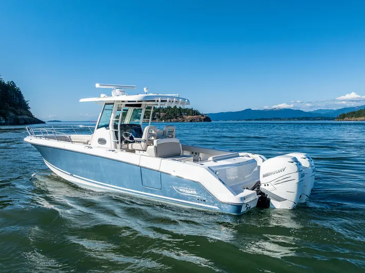  Yacht Photos Pics 2017 Boston Whaler 330 Outrage boat on scenic water with clear blue sky.