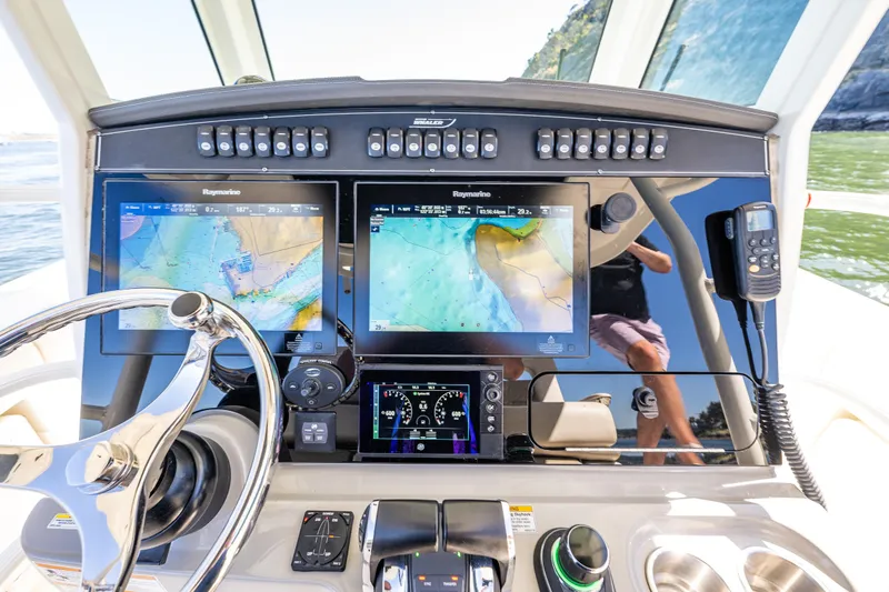 Yacht Photos Pics 2017 Boston Whaler 330 Outrage dashboard with navigation screens and controls.