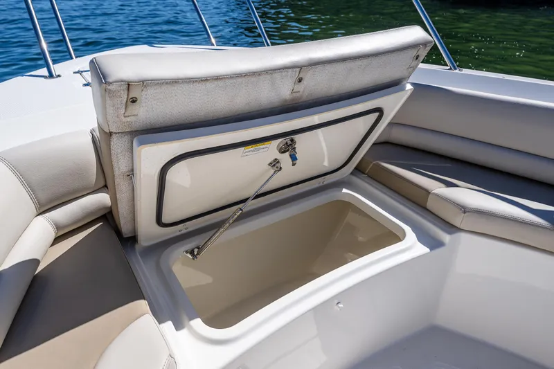  Yacht Photos Pics 2017 Boston Whaler 330 Outrage boat storage compartment open, revealing spacious interior.
