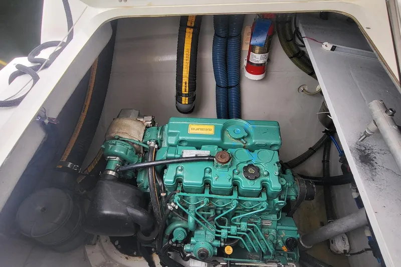 Knot On Call Yacht Photos Pics Engine compartment of a 2018 Fountaine Pajot Helia 44 catamaran, featuring a green marine engine.