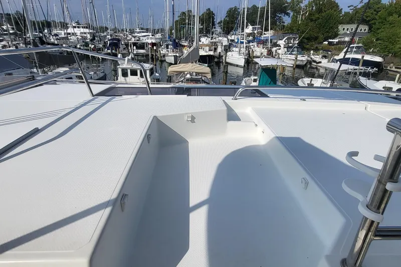 Knot On Call Yacht Photos Pics Fountaine Pajot Helia 44 catamaran deck, 2018 model, docked at a marina with multiple boats.
