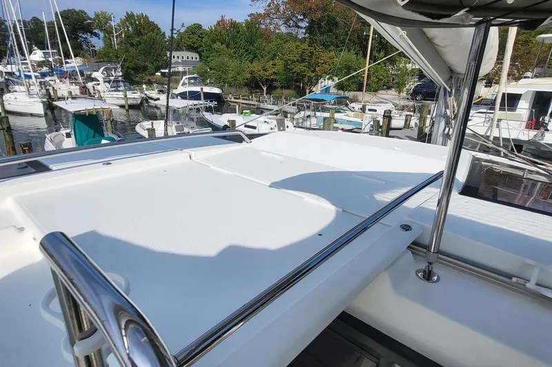 Knot On Call Yacht Photos Pics 2018 Fountaine Pajot Helia 44 catamaran docked at a marina, showcasing spacious deck.