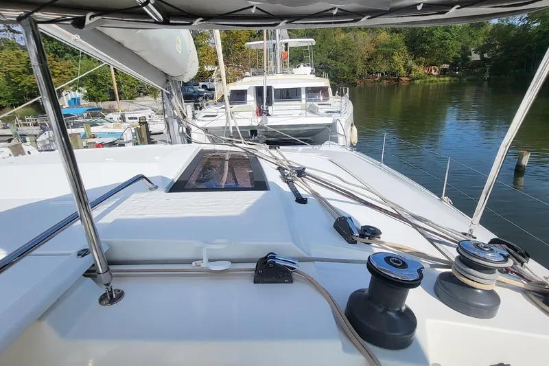 Knot On Call Yacht Photos Pics 2018 Fountaine Pajot Helia 44 catamaran docked in a serene marina setting.