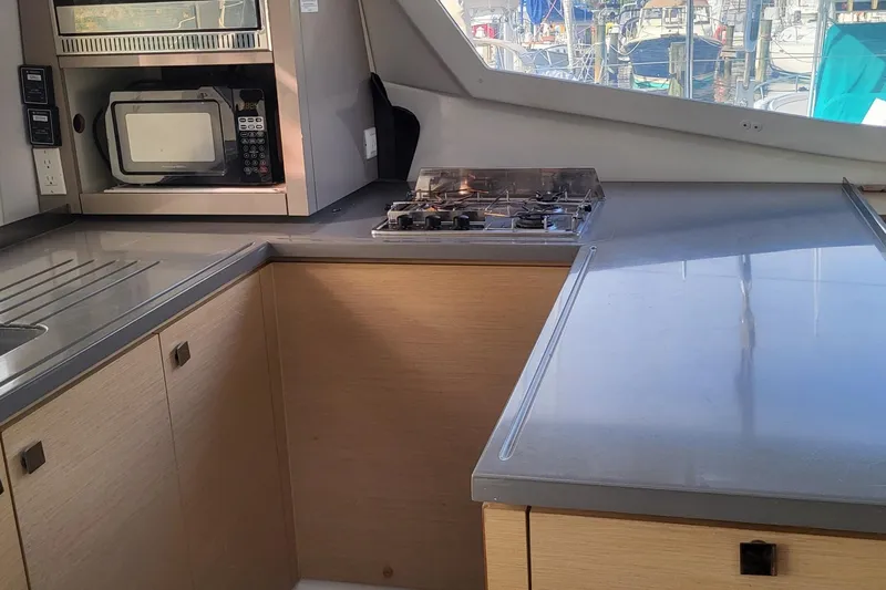 Knot On Call Yacht Photos Pics Modern kitchen interior of 2018 Fountaine Pajot Helia 44 catamaran with stove and microwave.