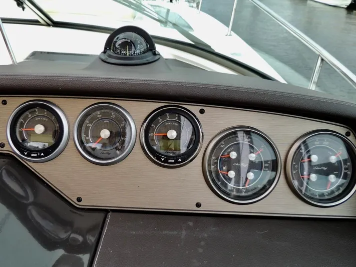 Yacht Photos Pics Dashboard of a 2016 Sea Ray 350 Sundancer boat with gauges and compass.