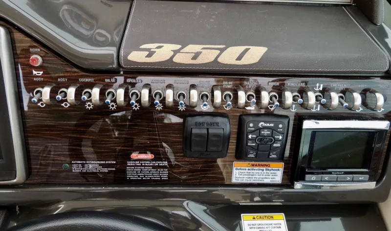  Yacht Photos Pics Control panel of a 2016 Sea Ray 350 Sundancer boat with various switches and displays.
