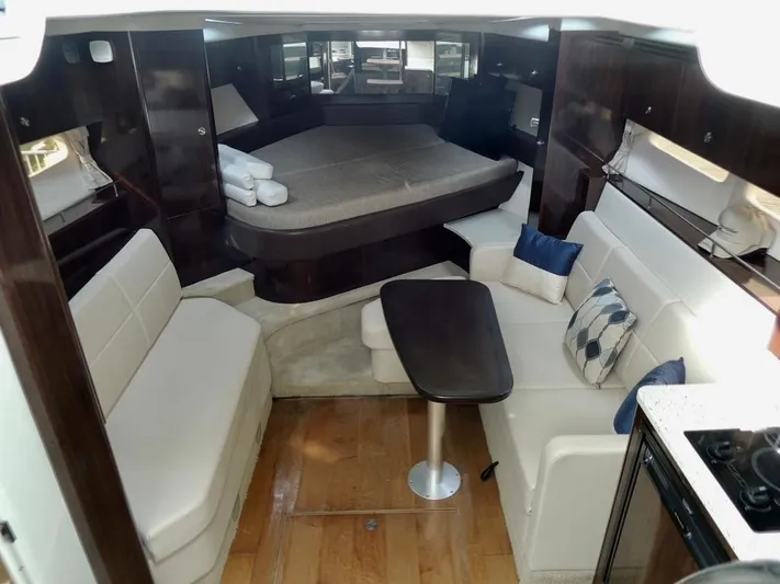  Yacht Photos Pics Interior of 2016 Sea Ray 350 Sundancer with seating, table, and bed.