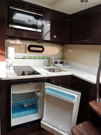  Yacht Photos Pics Modern kitchen area in 2016 Sea Ray 350 Sundancer yacht with microwave, sink, and mini-fridge.