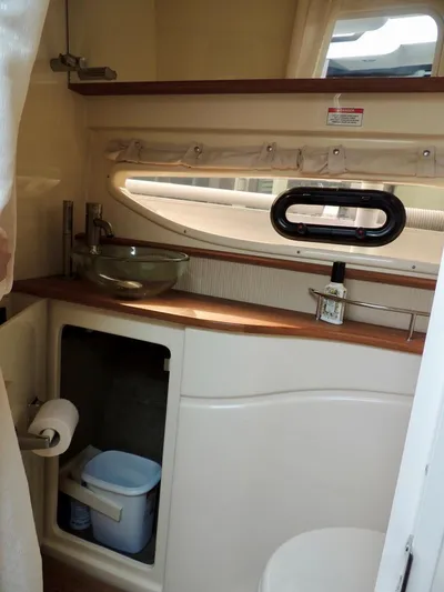  Yacht Photos Pics 2016 Sea Ray 350 Sundancer bathroom with sink, storage, and porthole window.