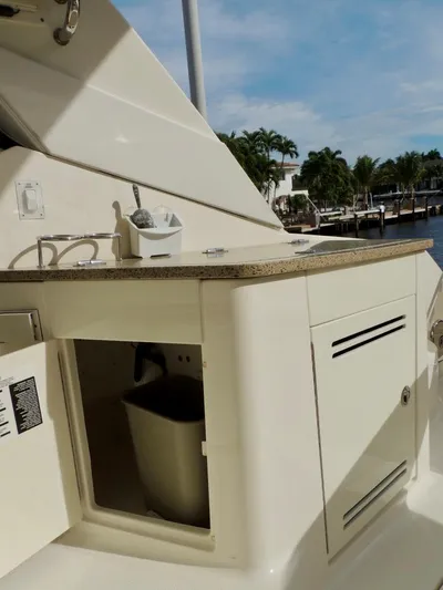  Yacht Photos Pics 2016 Sea Ray 350 Sundancer boat kitchenette with sink and storage.
