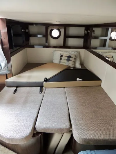  Yacht Photos Pics 2016 Sea Ray 350 Sundancer cabin interior with convertible seating and porthole windows.