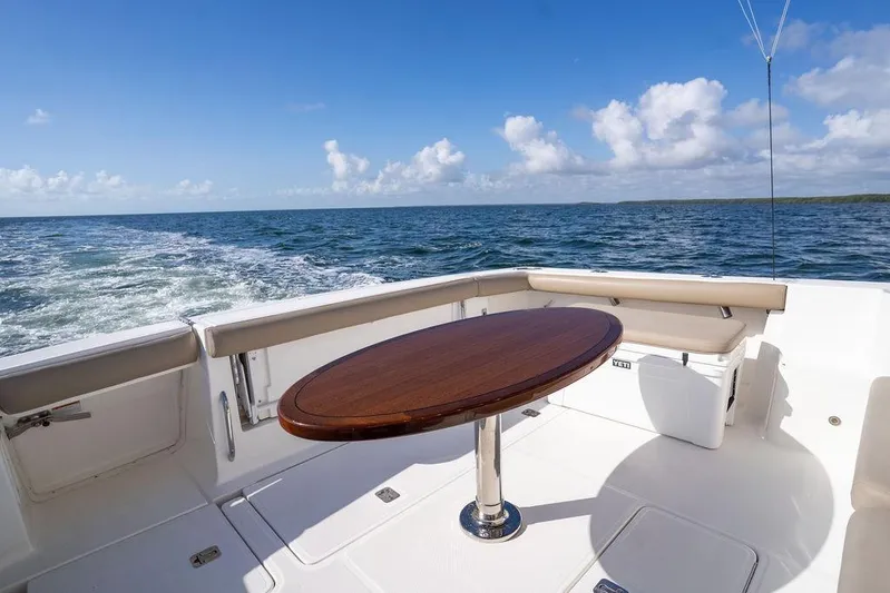  Yacht Photos Pics 2005 Tiara Yachts 4200 Open with ocean view, featuring a wooden table and cushioned seating.