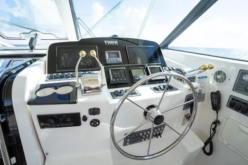  Yacht Photos Pics Helm of 2005 Tiara Yachts 4200 Open with steering wheel and navigation controls.
