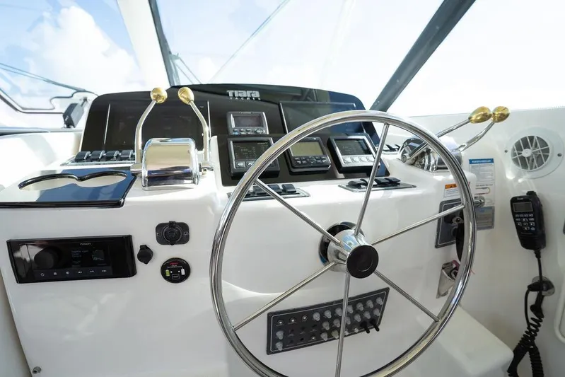 Yacht Photos Pics Helm of 2005 Tiara Yachts 4200 Open, featuring steering wheel and control panel.