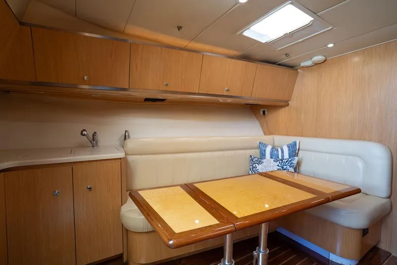  Yacht Photos Pics Interior of 2005 Tiara Yachts 4200 Open with wood cabinetry and cozy seating area.