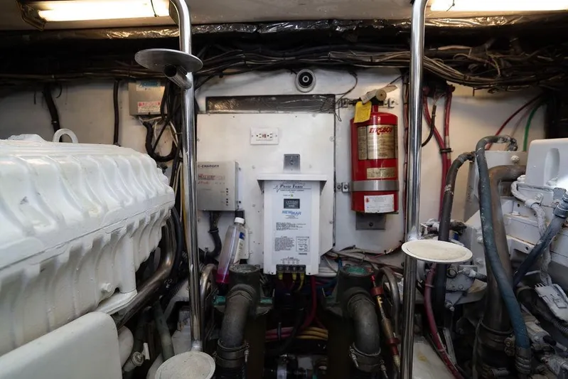  Yacht Photos Pics Engine room of a 2005 Tiara Yachts 4200 Open, featuring equipment and fire extinguisher.