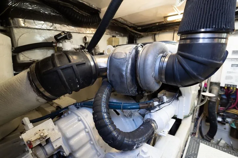  Yacht Photos Pics Engine room of 2005 Tiara Yachts 4200 Open, showcasing mechanical components and piping.