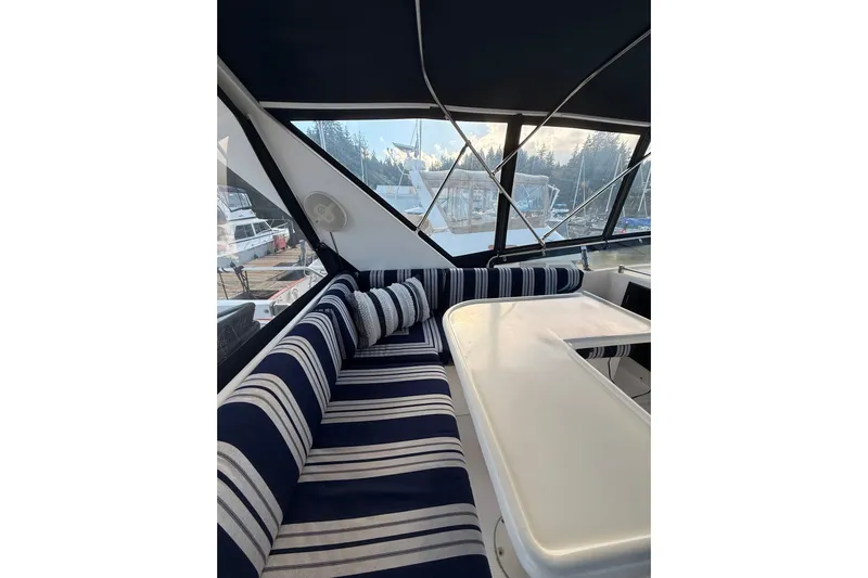 Island Girl Yacht Photos Pics Interior of 1997 Ocean Alexander 486 Pilothouse with striped seating and table.