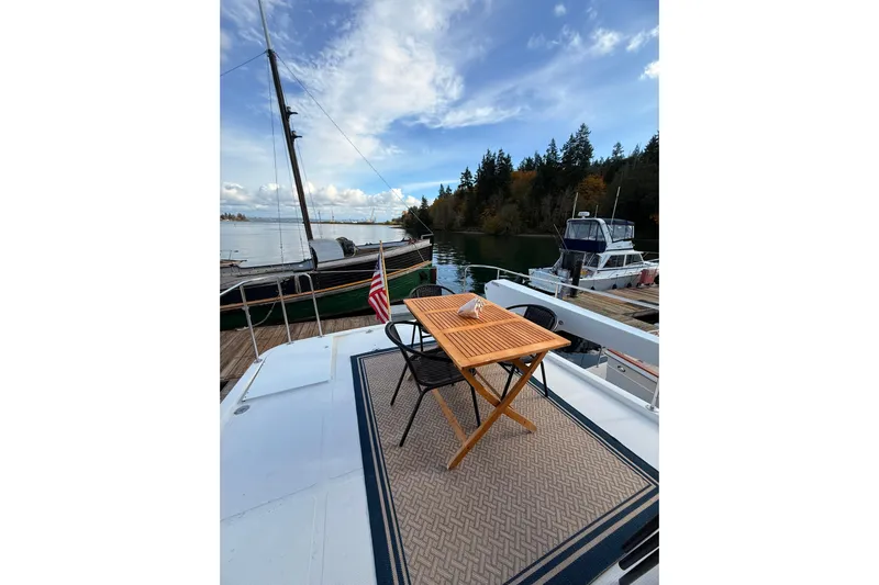 Island Girl Yacht Photos Pics 1997 Ocean Alexander 486 Pilothouse yacht with outdoor seating, docked in scenic marina.