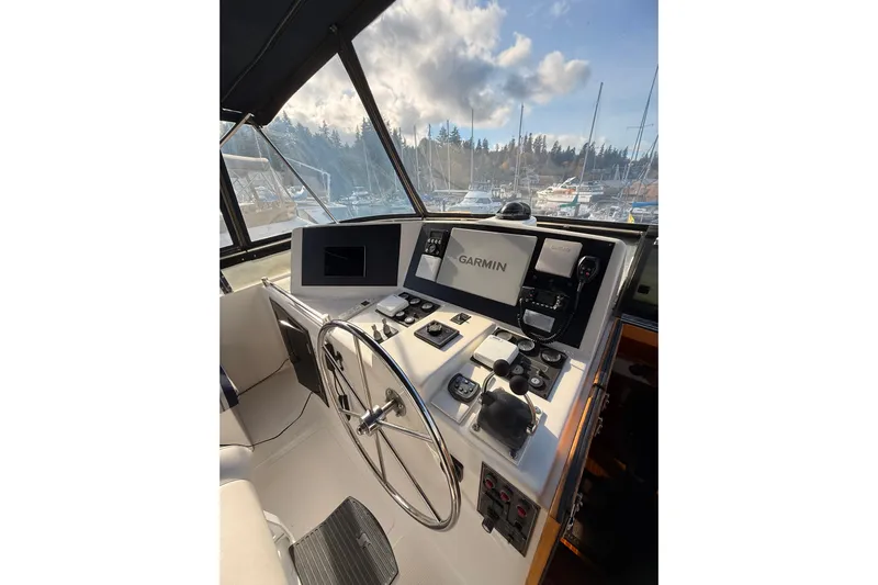 Island Girl Yacht Photos Pics 1997 Ocean Alexander 486 Pilothouse helm with Garmin navigation system, marina view.