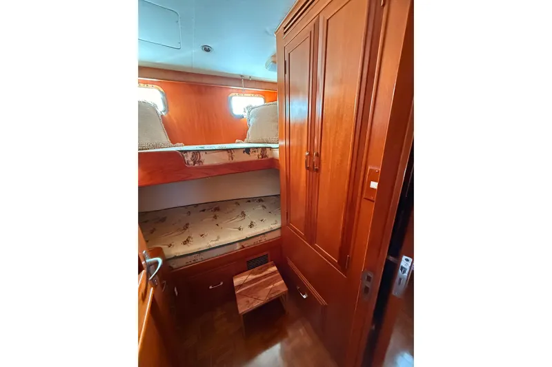 Island Girl Yacht Photos Pics Cozy cabin interior of 1997 Ocean Alexander 486 Pilothouse with wooden bunk beds.