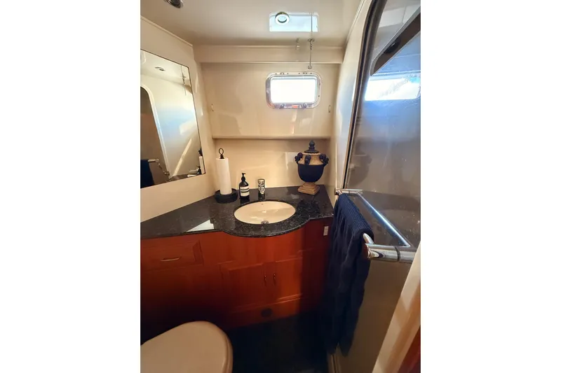 Island Girl Yacht Photos Pics Bathroom interior of 1997 Ocean Alexander 486 Pilothouse yacht, featuring sink and shower.